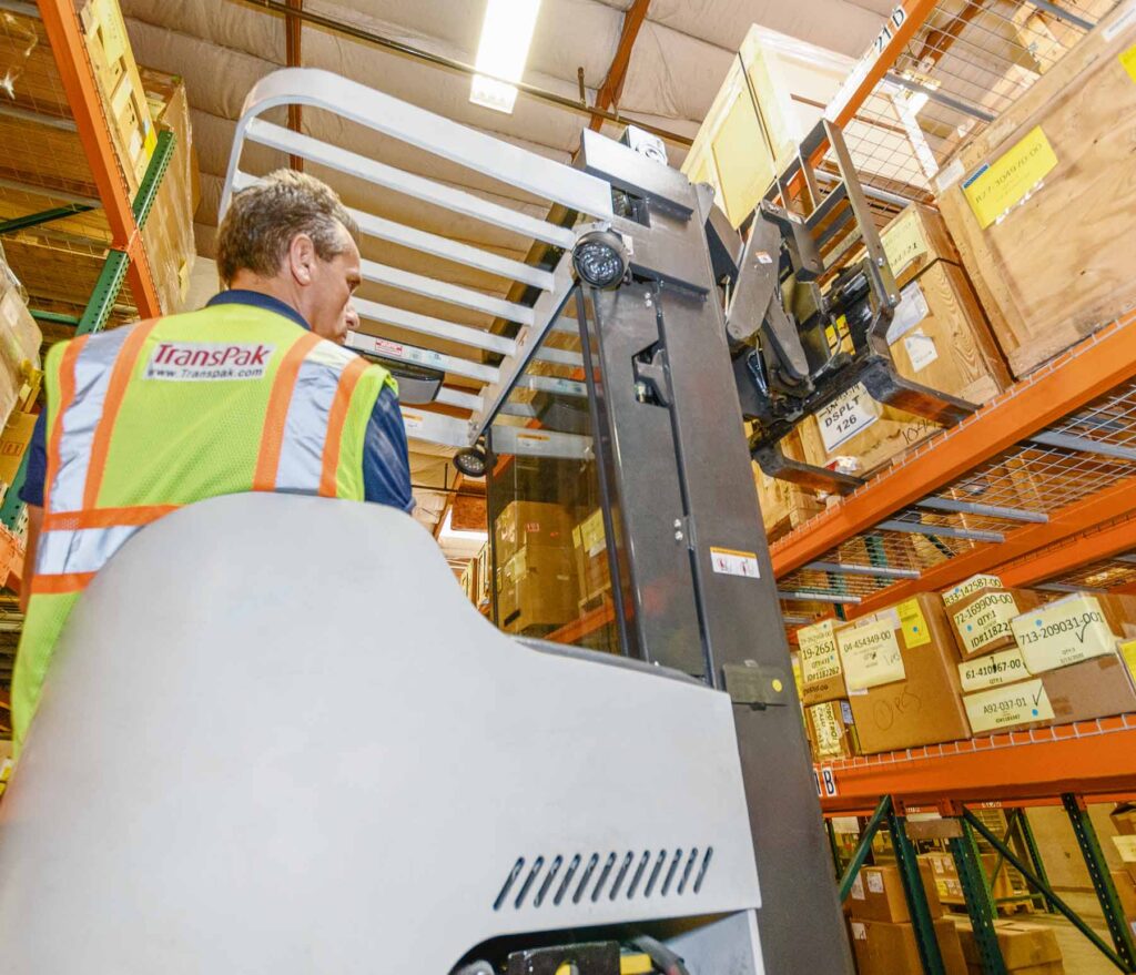 transpak-employee-using-forklift-to-load-order